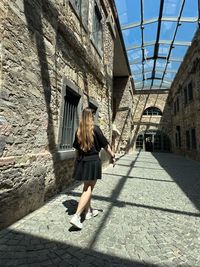 Rear view of woman walking on street