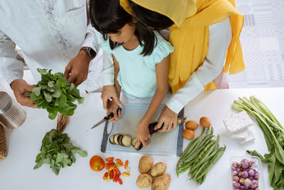 High angle view of women preparing food on table