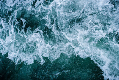Full frame shot of sea waves splashing on rocks