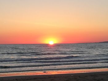 Scenic view of sea against orange sky