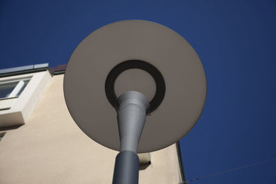 Low angle view of communications tower against blue sky