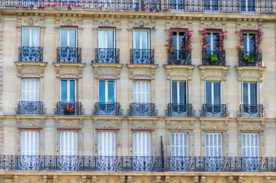 Typical architectural features of parisian buildings. stone facade with blu windows blids