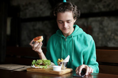 Portrait of boy eating food at home