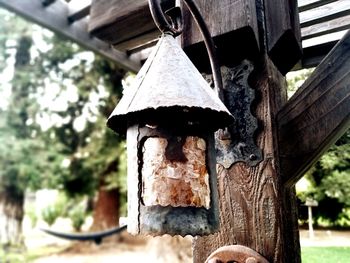 Low angle view of birdhouse hanging on tree