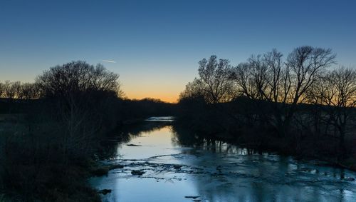 Scenic view of river at sunset