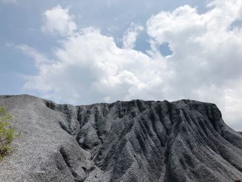 Low angle view of rock formations against sky