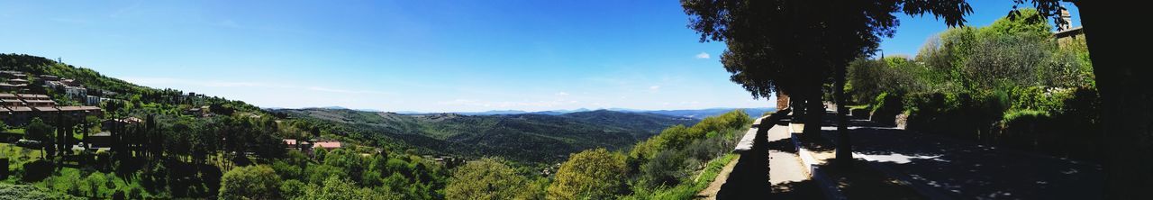 Panoramic view of landscape against blue sky