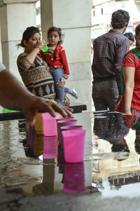 Rear view of people with reflection in water