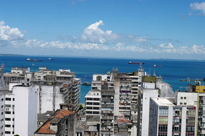 High angle view of buildings by sea against sky