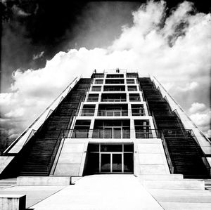 Low angle view of building against cloudy sky