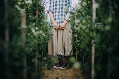 Woman standing by plants