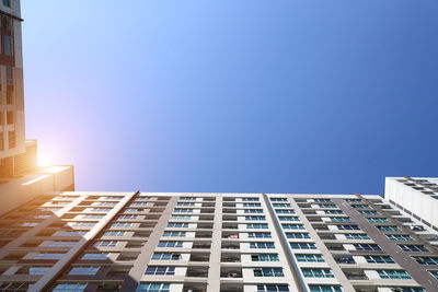 Low angle view of buildings against clear blue sky