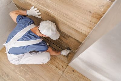 High angle view of woman working on hardwood floor