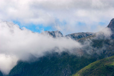 Scenic view of mountains against cloudy sky