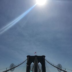 Low angle view of bridge against cloudy sky