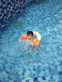 High angle view of boy swimming in pool