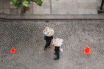 High angle view of people with food standing on street