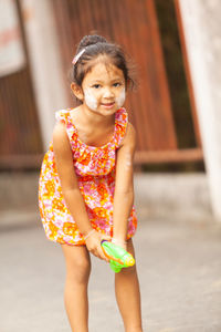 Portrait of smiling girl standing outdoors