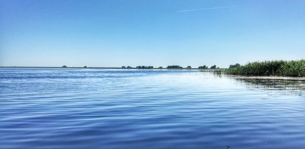 Scenic view of sea against clear blue sky