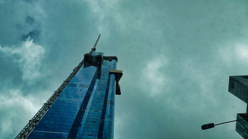 Low angle view of traditional building against cloudy sky