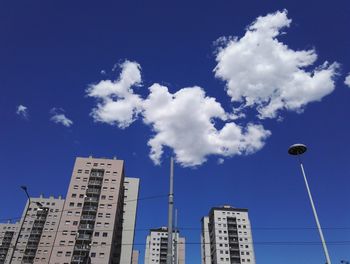 Low angle view of buildings against blue sky