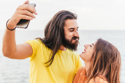 Portrait of young woman using mobile phone