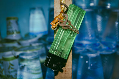 Close-up of leaf hanging from glass on table