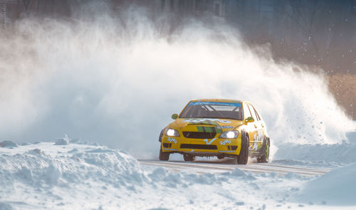 Panoramic view of snow covered car on mountain