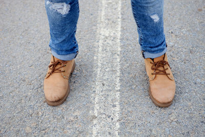 Low section of man standing on street