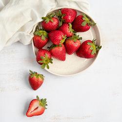 High angle view of strawberries in bowl on table