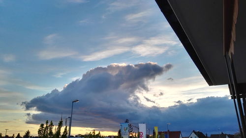 Low angle view of building against cloudy sky