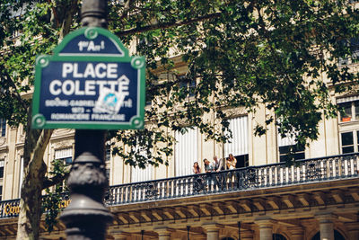 Information sign against trees in city