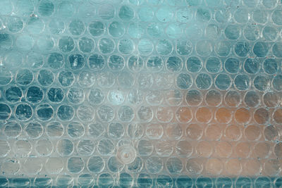 Close up of bubble wrap, used for isolation in front of blue background