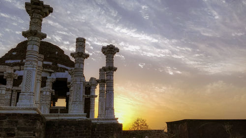 Low angle view of buildings against sky during sunset