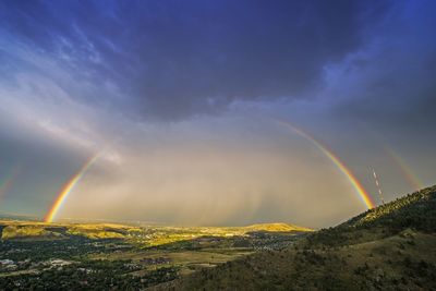 Rainbow over mountain against sky