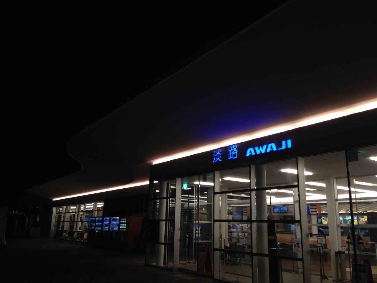 architecture, built structure, illuminated, text, night, western script, building exterior, communication, low angle view, railroad station, indoors, city, building, modern, window, information sign, non-western script, information, incidental people, railroad station platform