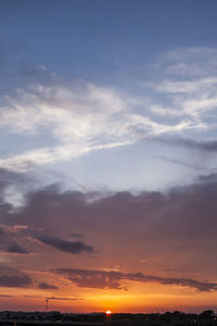 Scenic view of silhouette beach against sky during sunset