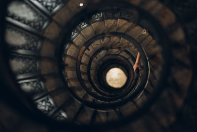 Directly above shot of spiral staircase with hand on railing