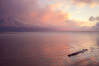 Scenic view of sea against sky at sunset