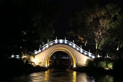 Illuminated building against sky at night