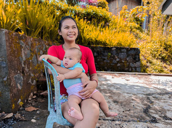 Portrait of a smiling girl sitting outdoors