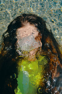 High angle view of woman swimming in lake