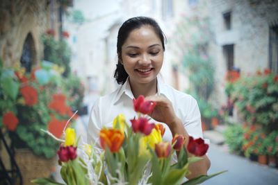 Woman looking at flower bouquet