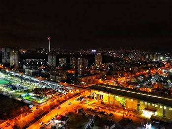 High angle view of illuminated cityscape against sky at night