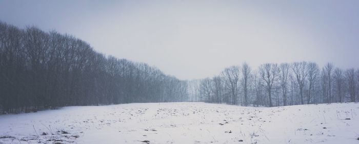 Scenic view of snow covered landscape against clear sky