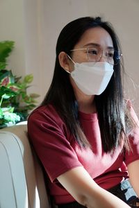 Portrait of smiling young woman drinking milk at home