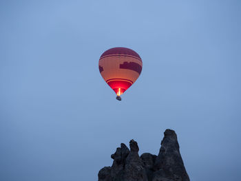 Low angle view of hot air balloon against clear blue sky