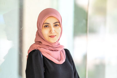 Portrait of smiling young woman standing outdoors