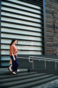 Women walking on staircase in city