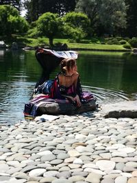 Rear view of woman sitting in lake